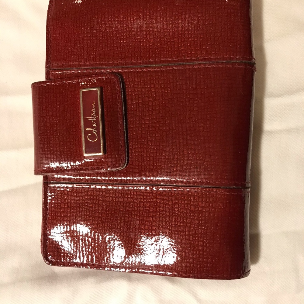 Dark pink patent leather Cole Haan passport wallet